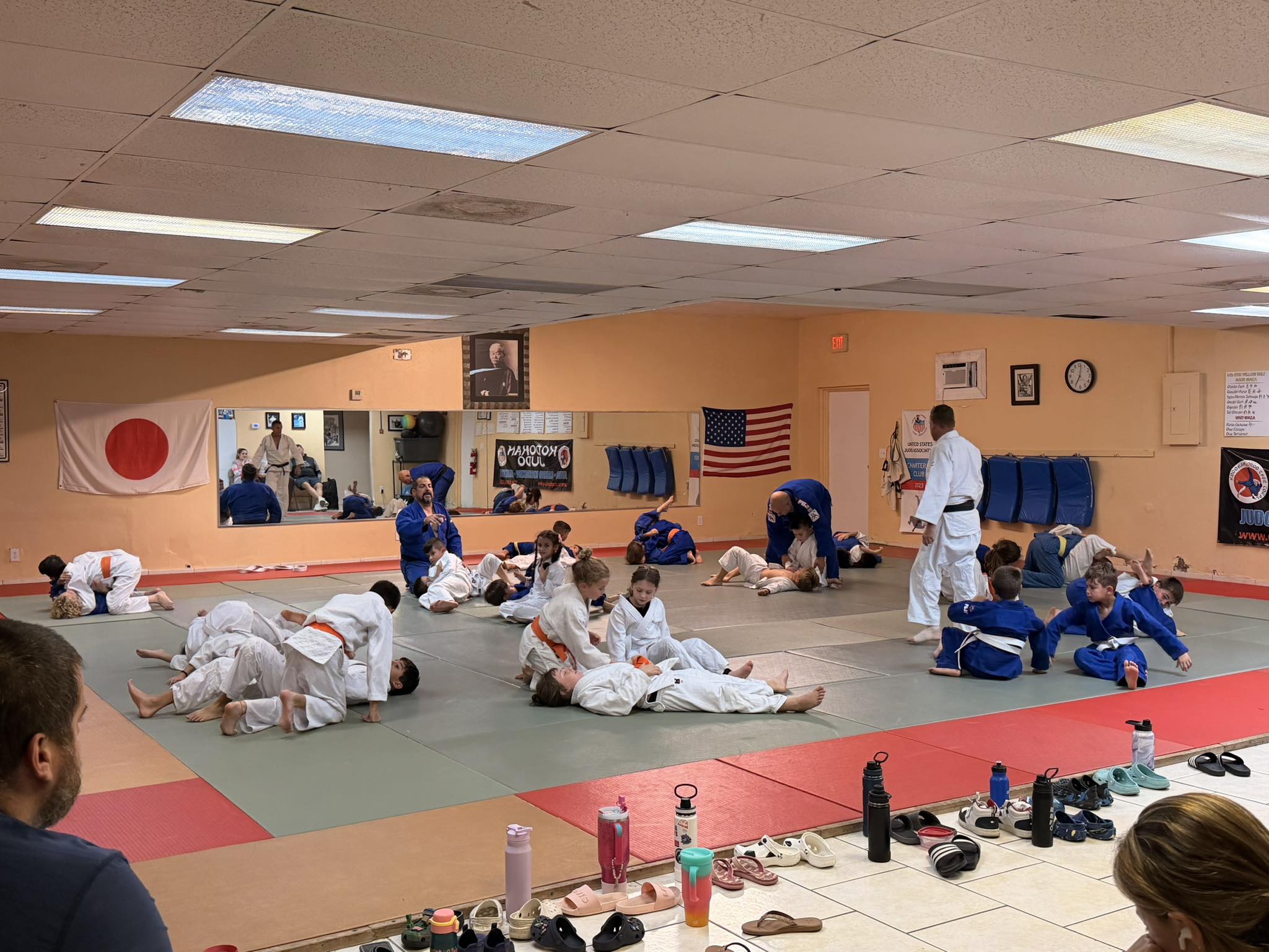 Kids judo class practicing groundwork on the mat